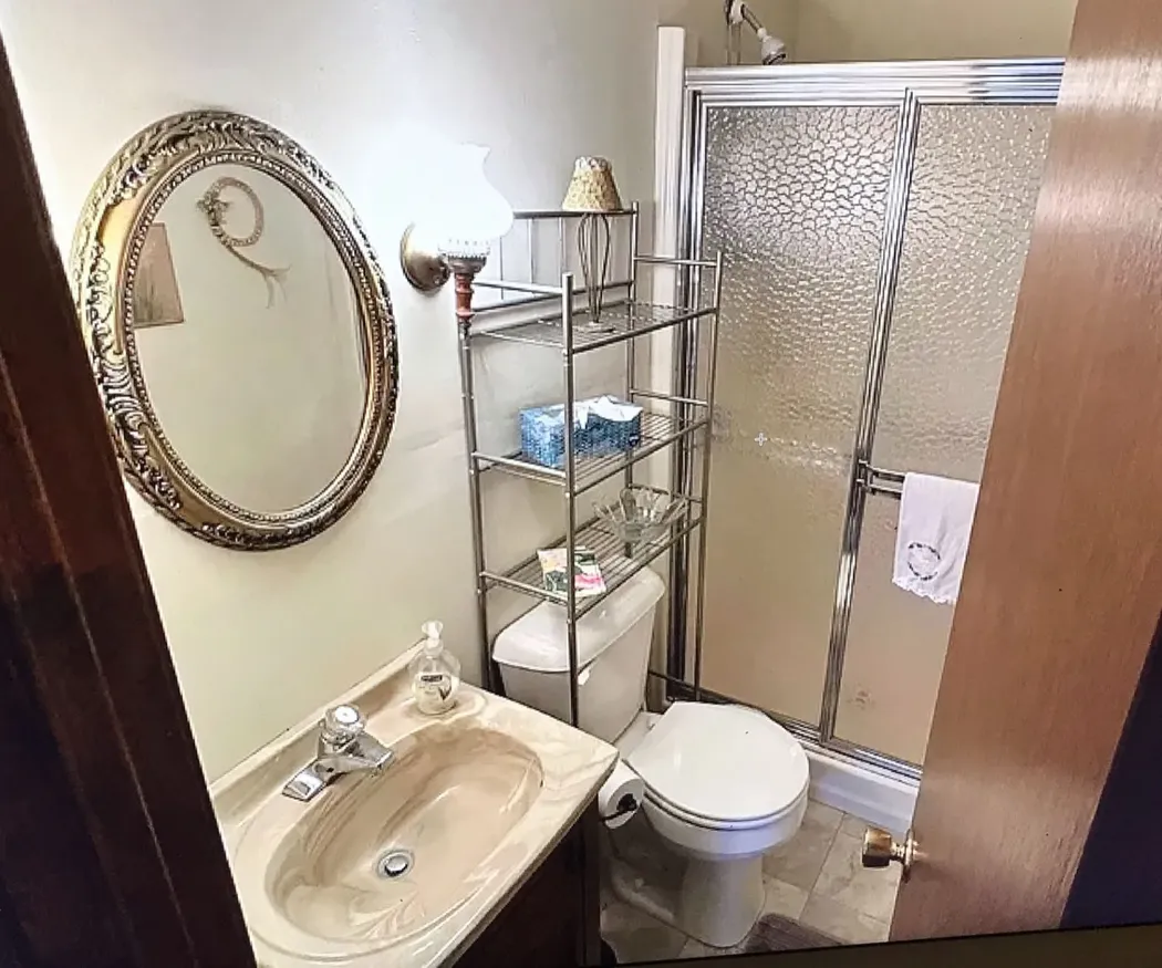 Chambersburg, PA bathroom before remodel with original fiberglass shower stall and dated vanity