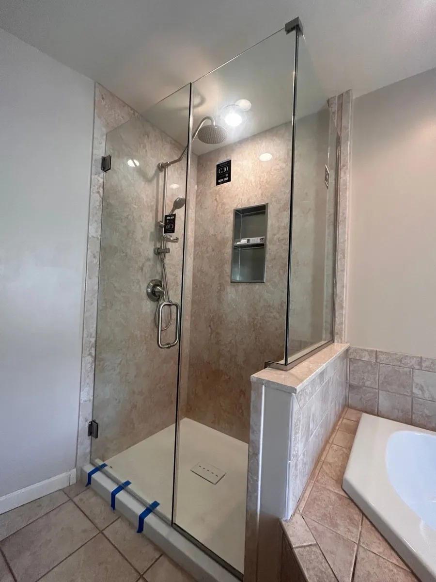 Angled view of the custom acrylic shower showing the built-in niche